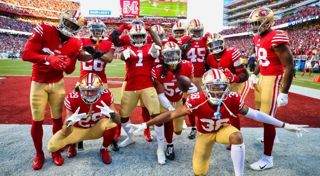 49ers defensive players celebrate a turnover.
