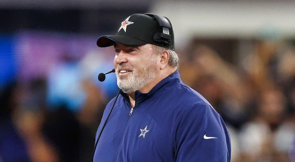 Mike McCarthy of Dallas Cowboys looking on.
