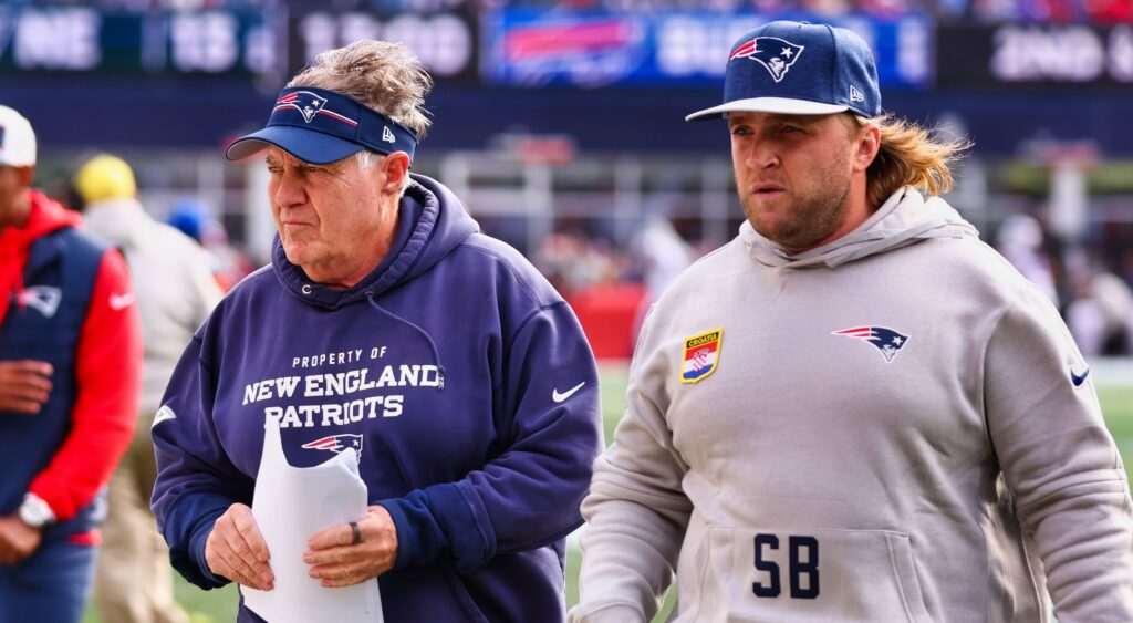 Bill Belichick (left) and Steve Belichick (right) walking along during game.