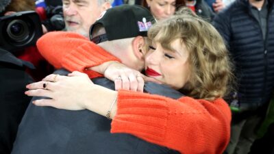 Taylor Swift hugging Travis Kelce