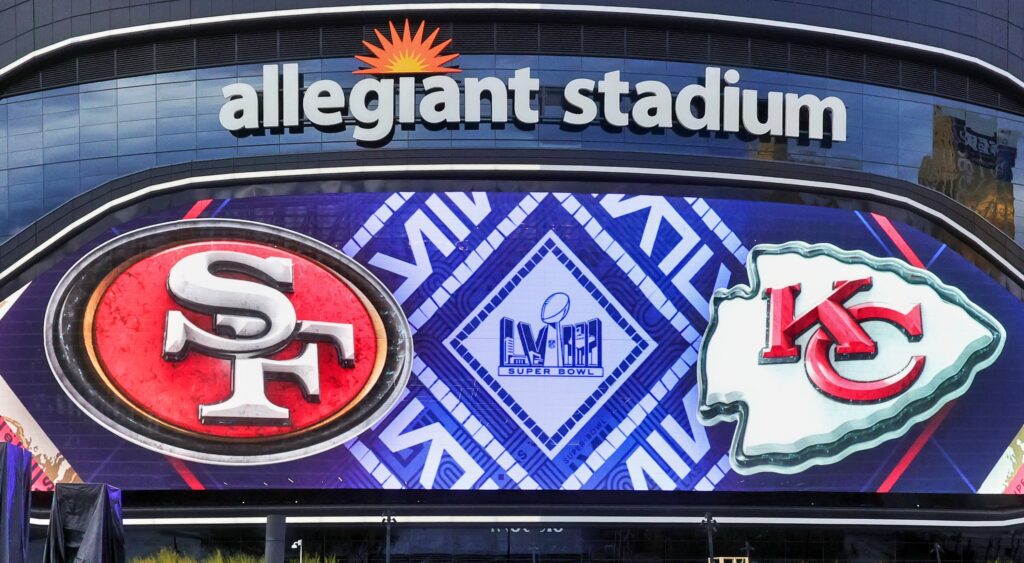 Outside view of Allegiant Stadium with 49ers and Chiefs logos.
