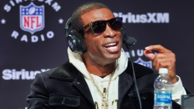 Dein Sanders speaking with sunglasses and headset on
