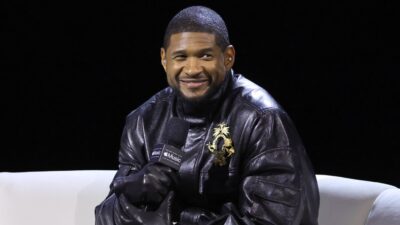 Usher seated on couch