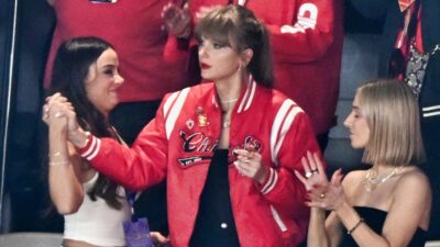 Taylor Swift in Chiefs jacket in suite