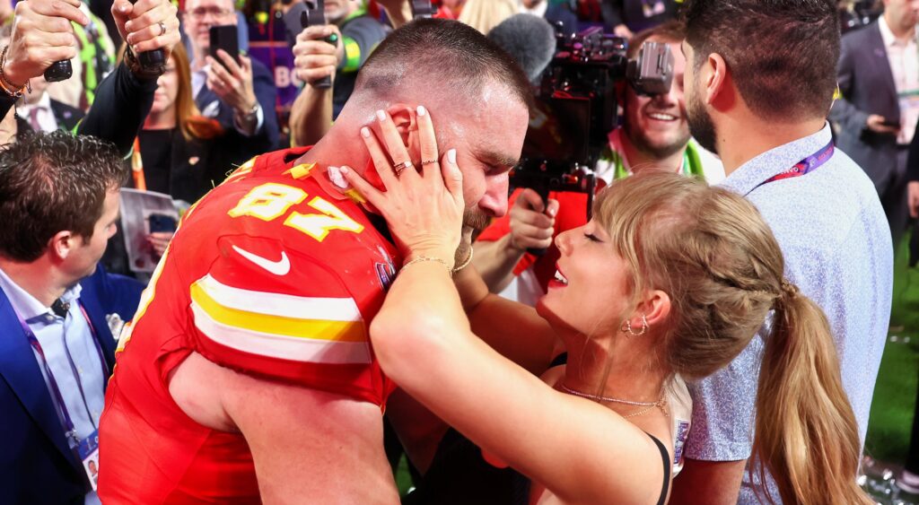 Travis Kelce and Taylor Swift embracing after Super Bowl 58.
