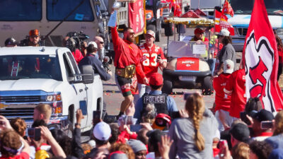 Travis Kelce raising Lombardi Trophy at Chiefs parade