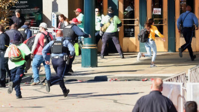 Civilians and officers running after shots are fired during Chiefs victory parade