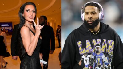 Kim Kardashian throwing up a peace sign. Odell in hoodie.