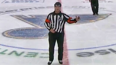 NHL referee motioning a call