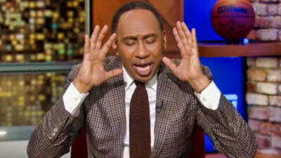Stephen A. Smith with his hands near his head