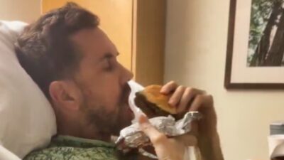 matt leinart eating a burger in hospital bed