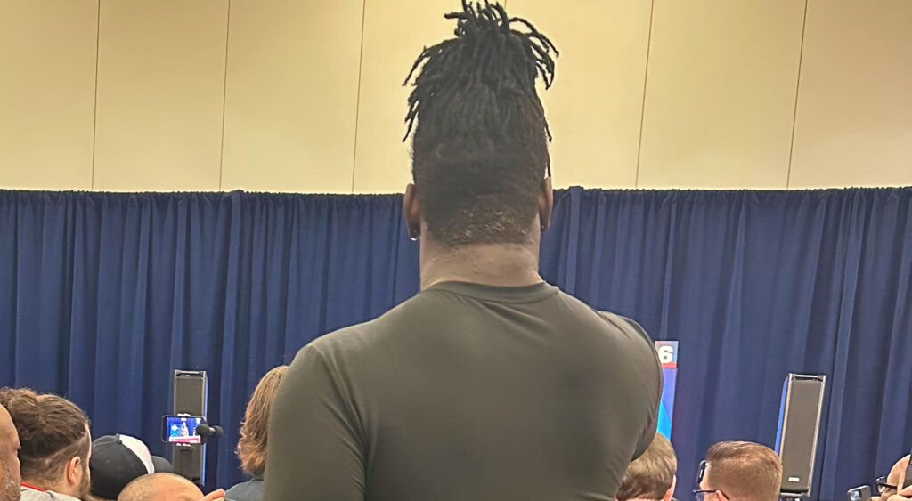 Amarius Mims' standing behind reporters at NFL Combine