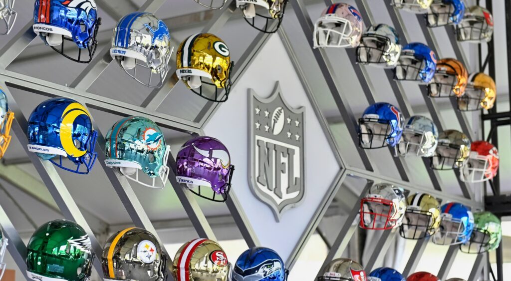 NFL Draft display shows helmets from every team on a wall.