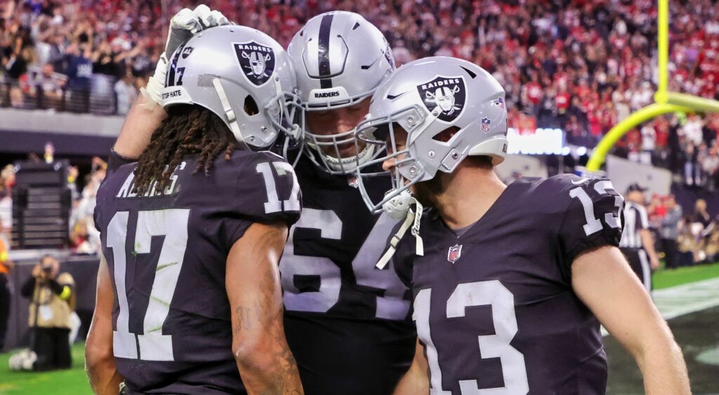 Raiders players in huddle