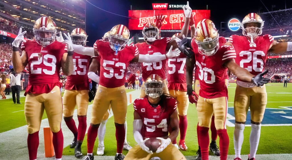 San Francisco 49ers players celebrating an interception.