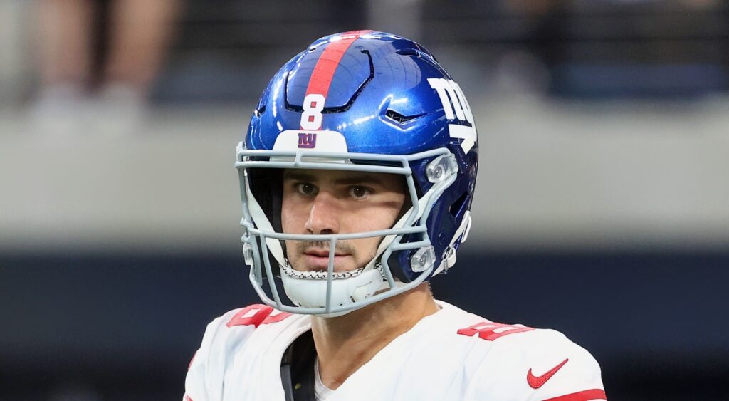 New York Giants quarterback Daniel Jones looking on.