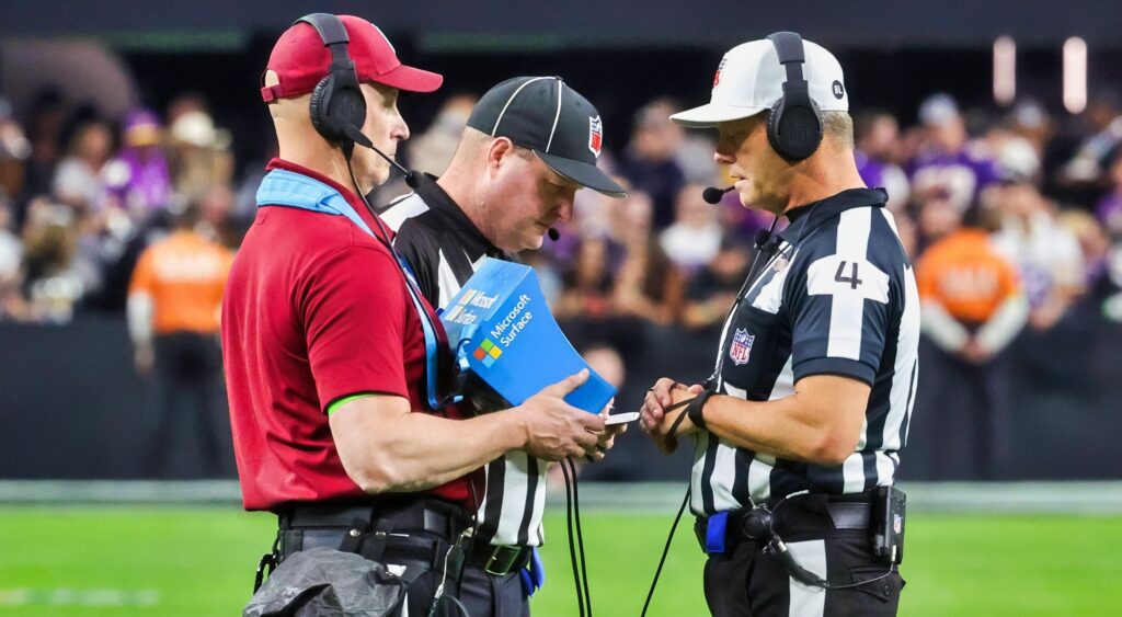 Referees review a play on the field. A new NFL rule could be coming to replay review.