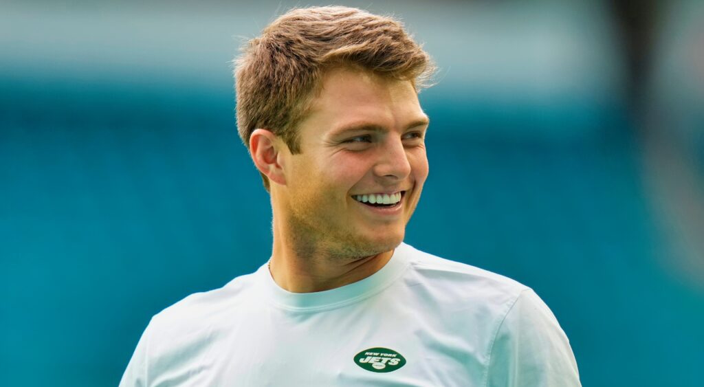 Zach Wilson in Jets shirt and smiling