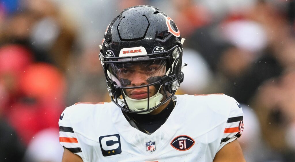 Chicago Bears quarterback Justin Fields looking on.