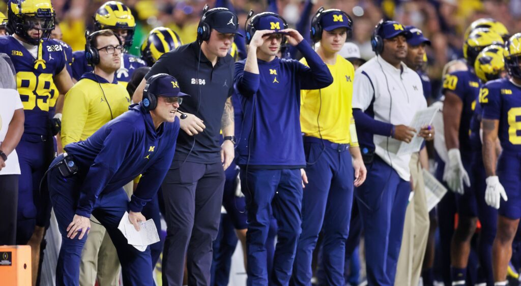 Michigan Wolverines coaches on the sideline.