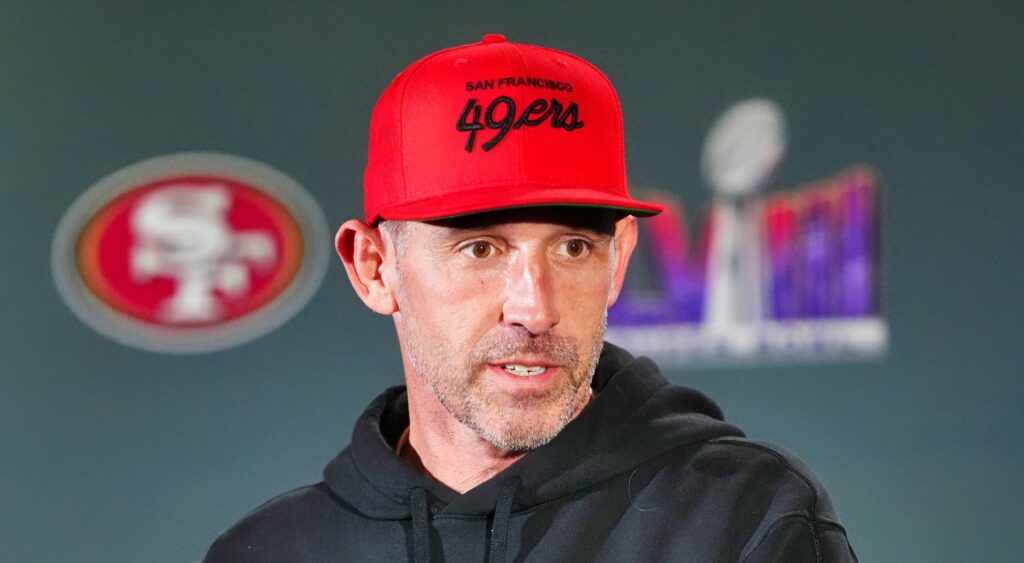 San Francisco 49ers coach Kyle Shanahan looking on.