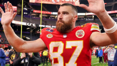 Travis Kelce with his hands in the air
