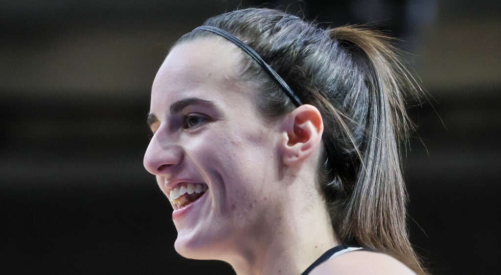 Caitlin Clark laughs during a game.