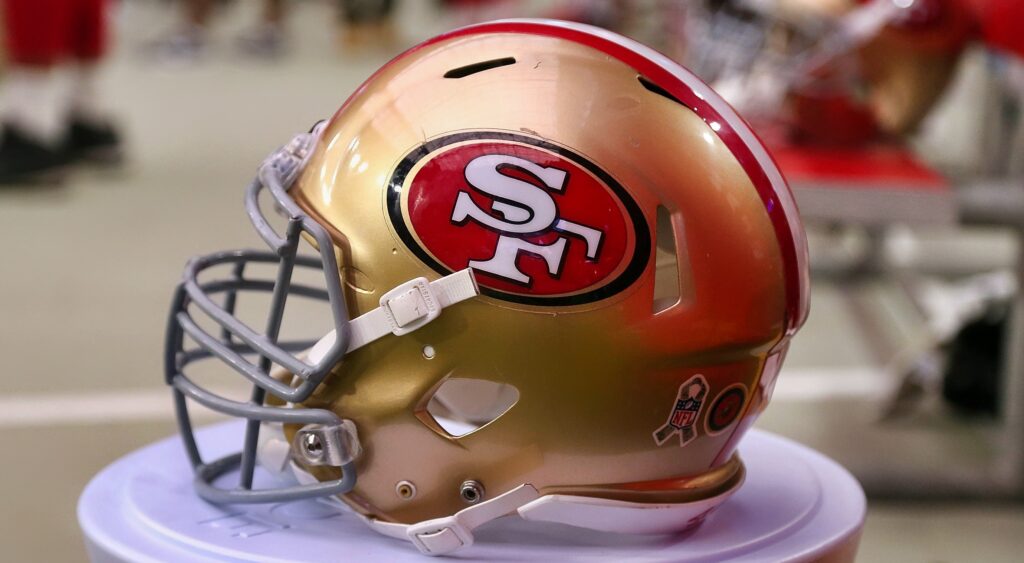San Francisco 49ers helmet shown on ground.