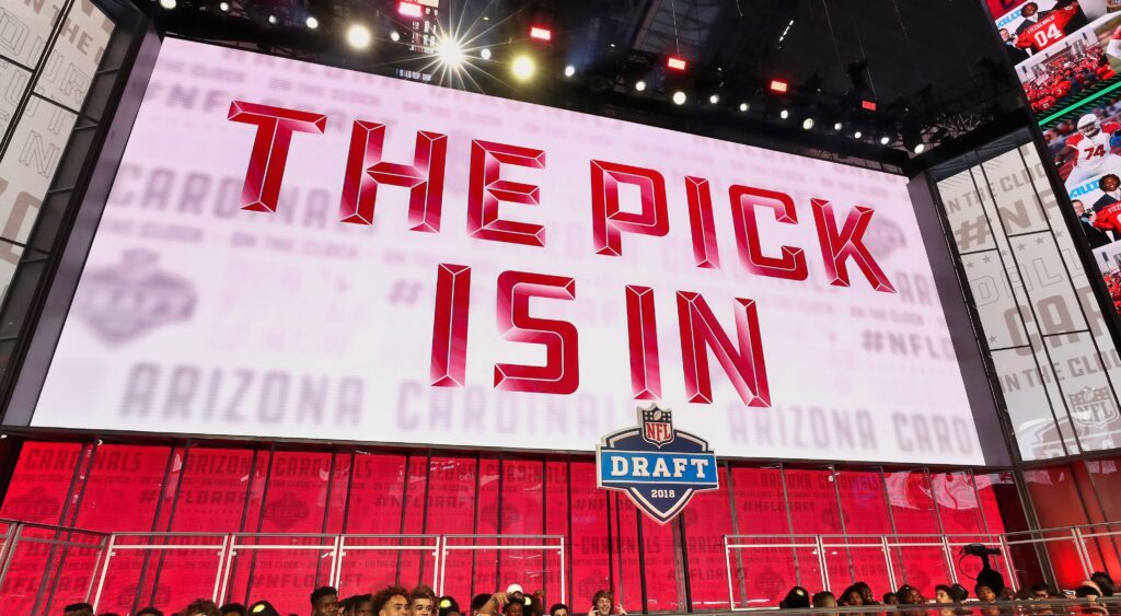 "The Pick Is In" appears on the board at the NFL Draft.