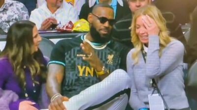LeBron James sitting between Linda Rambis and Jeanie Buss