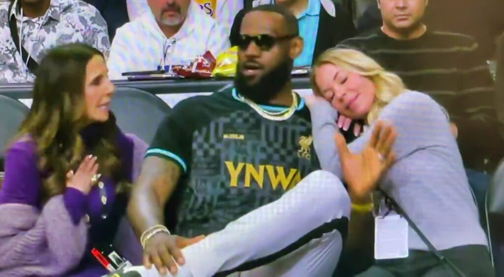 Jeanie Buss resting on LeBron James' shoulder