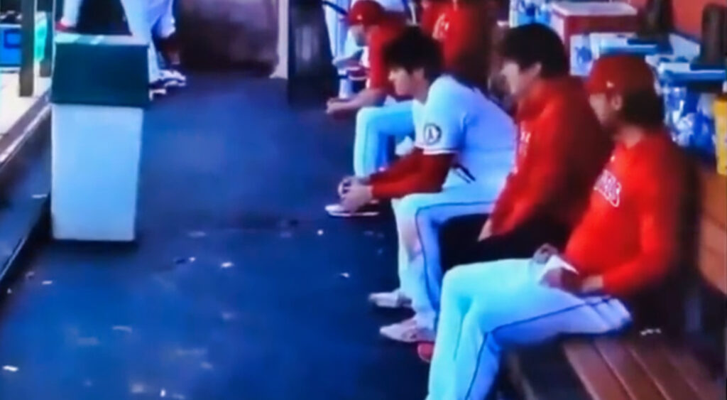 Shohei Ohtani sitting in dugout during game