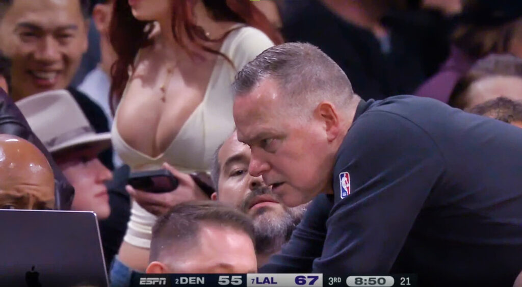 female fan in Mike Malone's background at Nuggets-Lakers game