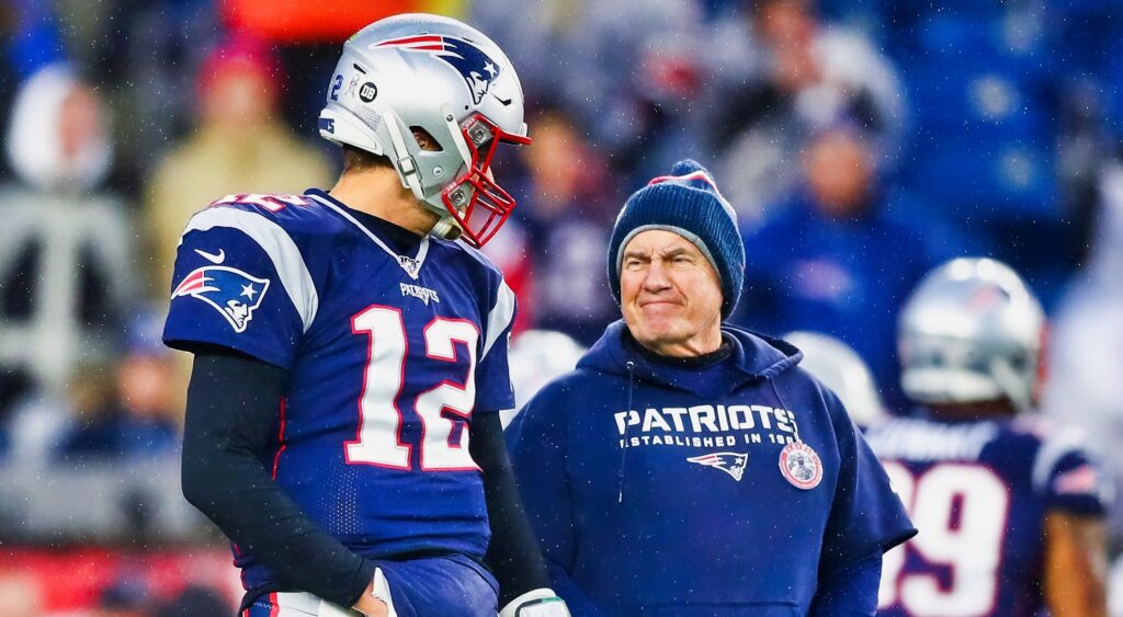 Tom Brady and Bill Belichick talk on the field before a game.