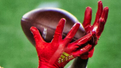 Brandon Aiyuk's hands around a football