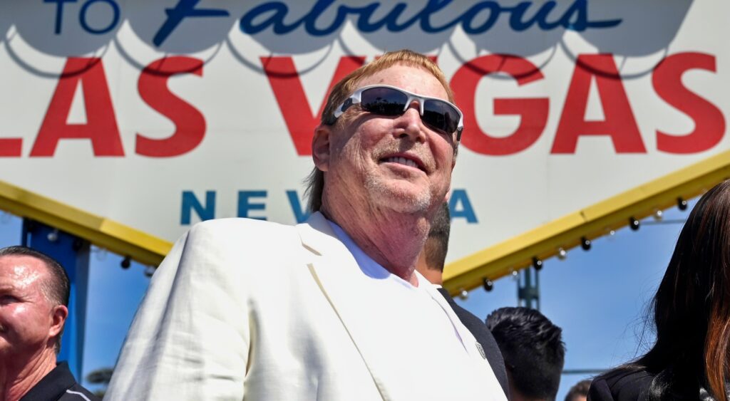 Mark Davis looks on while standing in front of the Las Vegas sign.