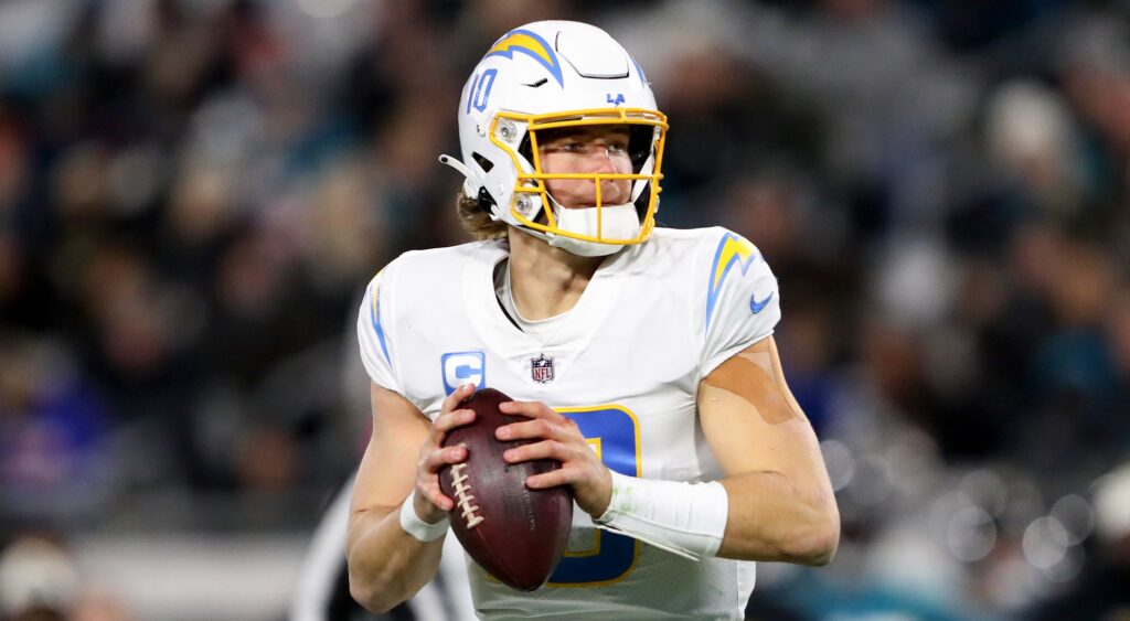 Justin Herbert of Los Angeles Chargers throwing football.