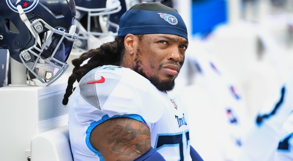 Derrick Henry looks on while sitting on the bench.