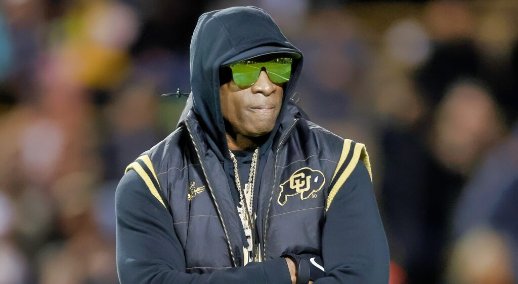 Deion Sanders with his arms folded