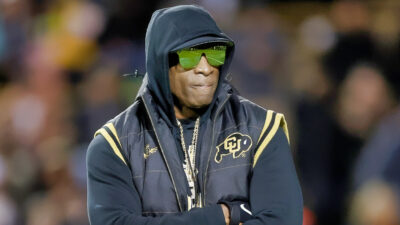 Deion Sanders with his arms folded
