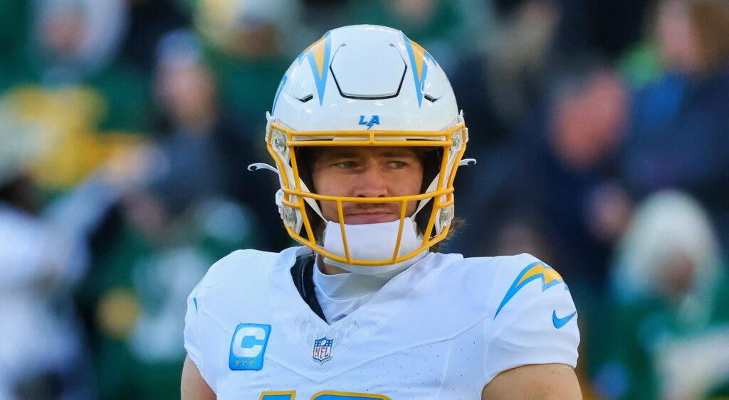 Justin Herbert of Los Angeles Chargers looking on.