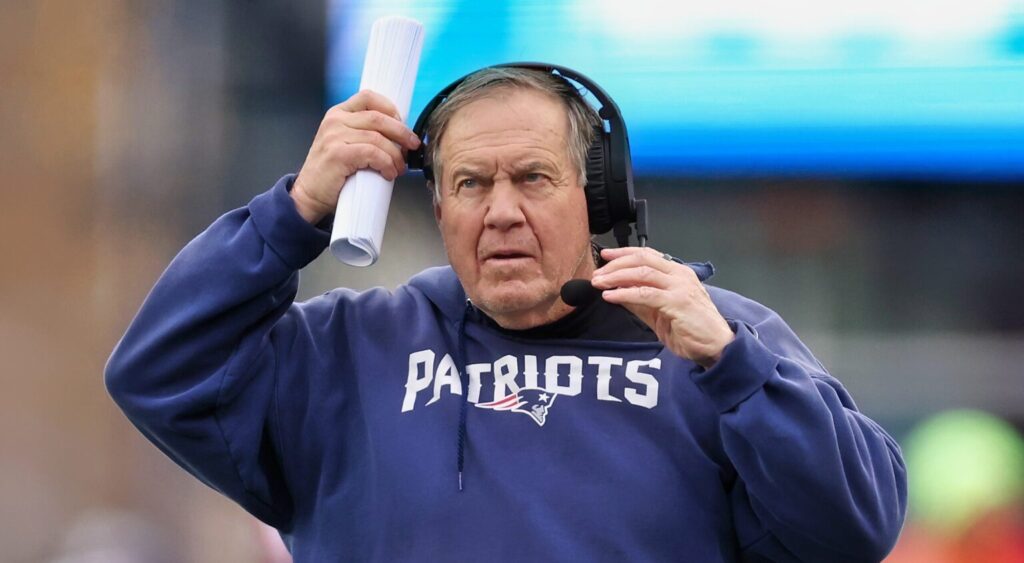 Bill Belichick of New England Patriots looking on.