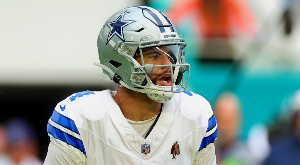 Dallas Cowboys quarterback Dak Prescott looking on.