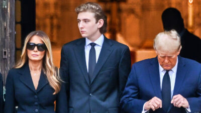 Barron Trump standing with his parents