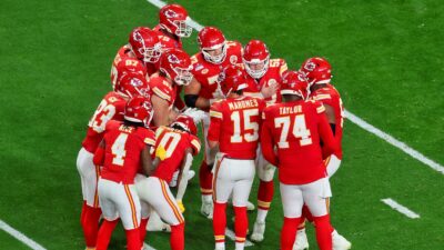 Kansas City Chiefs players in huddle