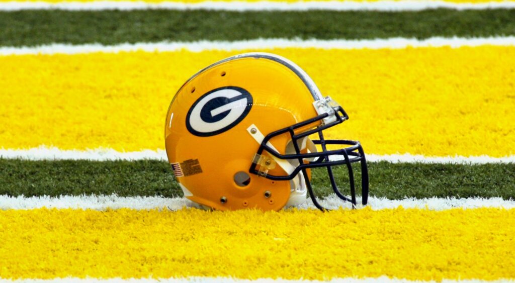 Green Bay Packers helmet on the field. Former Packers OL coach Larry Beightol recently passed away.