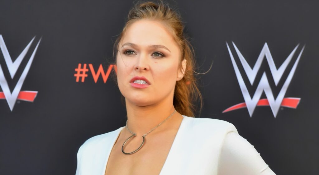 Ronda Rousey poses on red carpet at a WWE event.