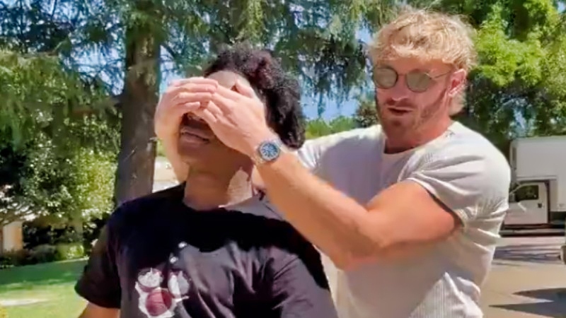 IShowSpeed walking with Logan Paul covering his eyes.