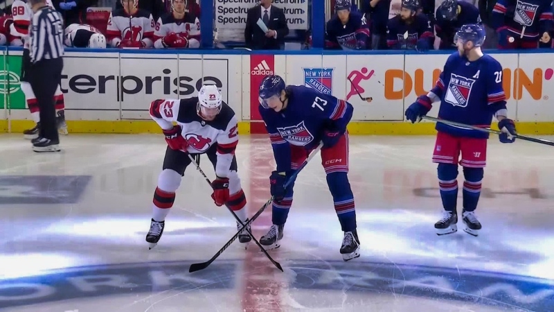 New York Rangers and New Jersey Devils preparing for a faceoff.