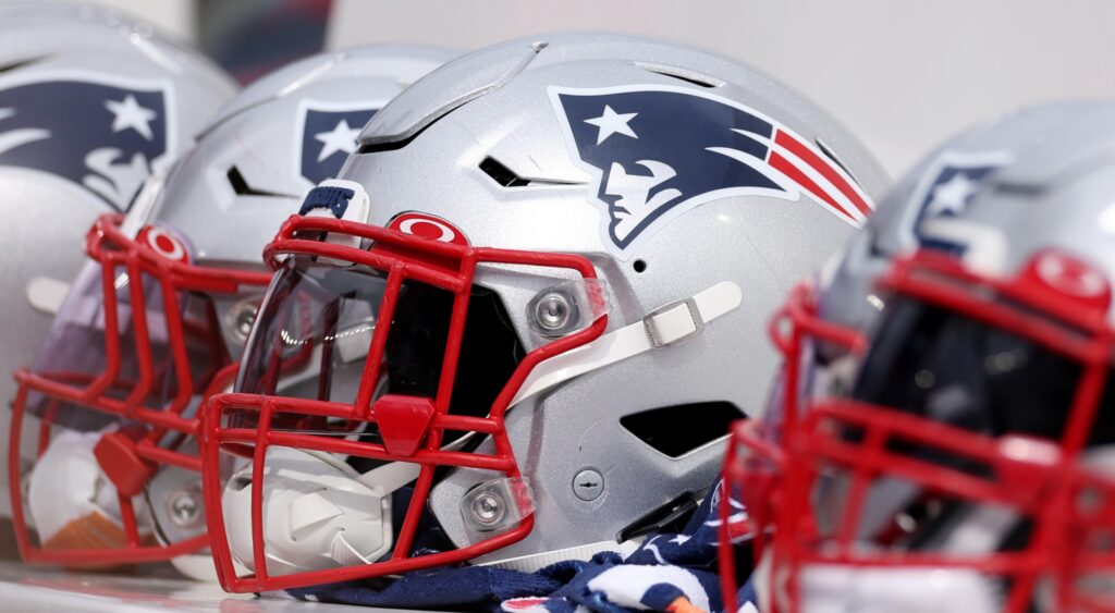 New England Patriots helmets on the bench during a game